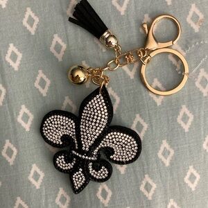 Rhinestone Cowgirl Black Fleur De Lis Keychain NWOT. Has Tassel and gold ball.